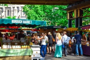 Lively scene at Borough Market in London, filled with people shopping and enjoying the atmosphere.